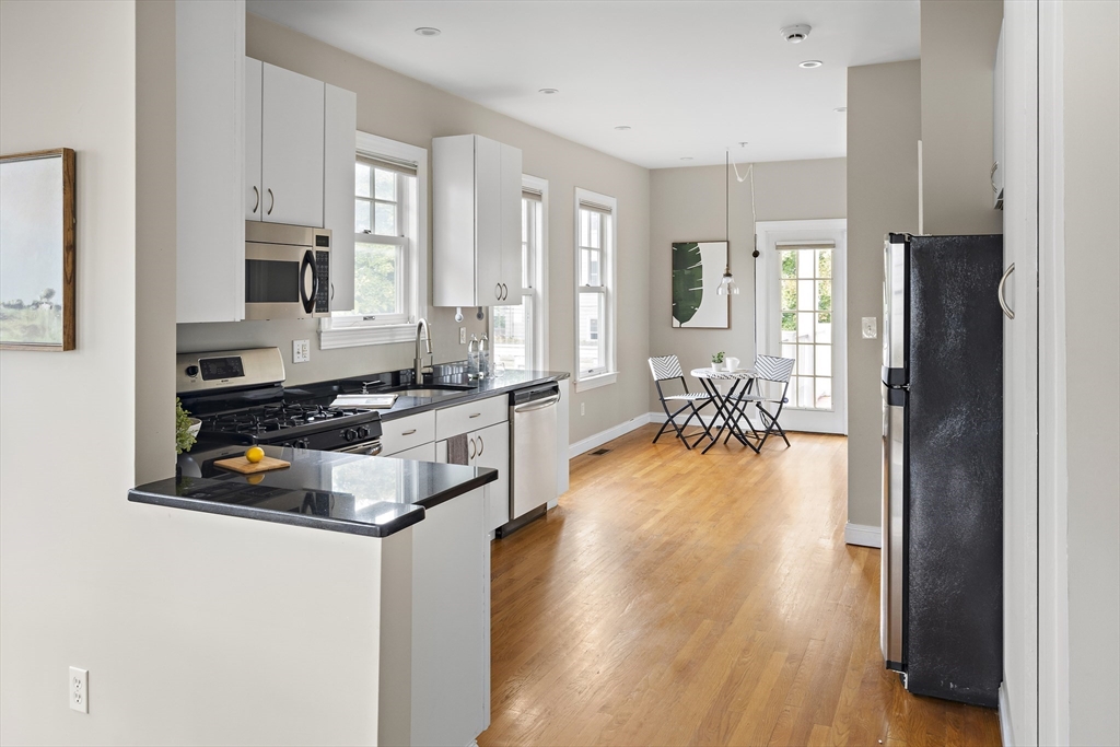 9 Cedar Street, Unit 2 Somerville, MA 02143 - Photo 11 of 20 a living room with stainless steel appliances granite countertop furniture and a wooden floor