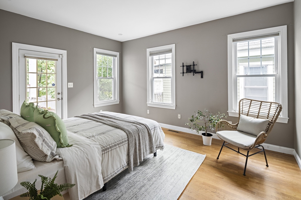 9 Cedar Street, Unit 2 Somerville, MA 02143 - Photo 12 of 20 a spacious bedroom with a bed and windows
