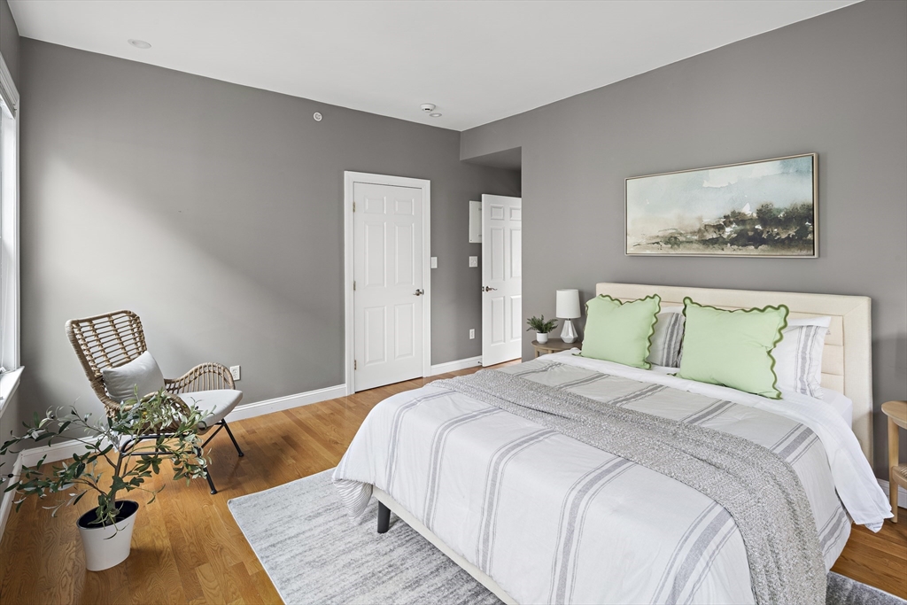 9 Cedar Street, Unit 2 Somerville, MA 02143 - Photo 13 of 20 a bedroom with a bed and chair