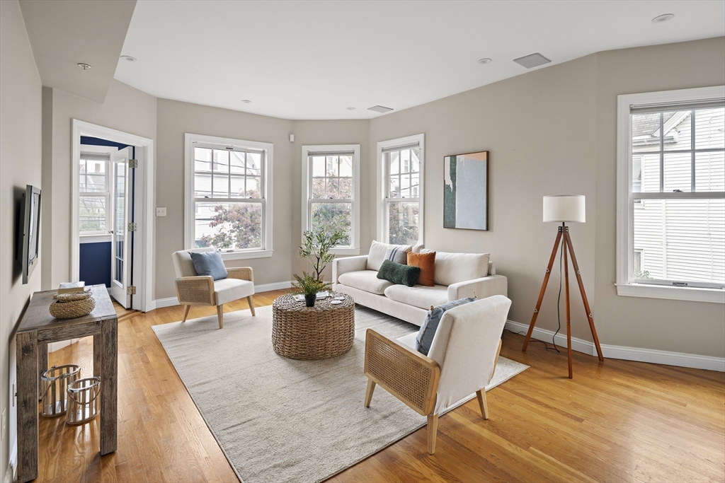 9 Cedar Street, Unit 2 Somerville, MA 02143 - Photo 3 of 20 a living room with furniture and a wooden floor