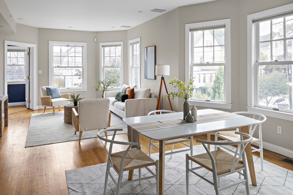 9 Cedar Street, Unit 2 Somerville, MA 02143 - Photo 6 of 20 a view of a dining room with furniture wooden floor and a chandelier