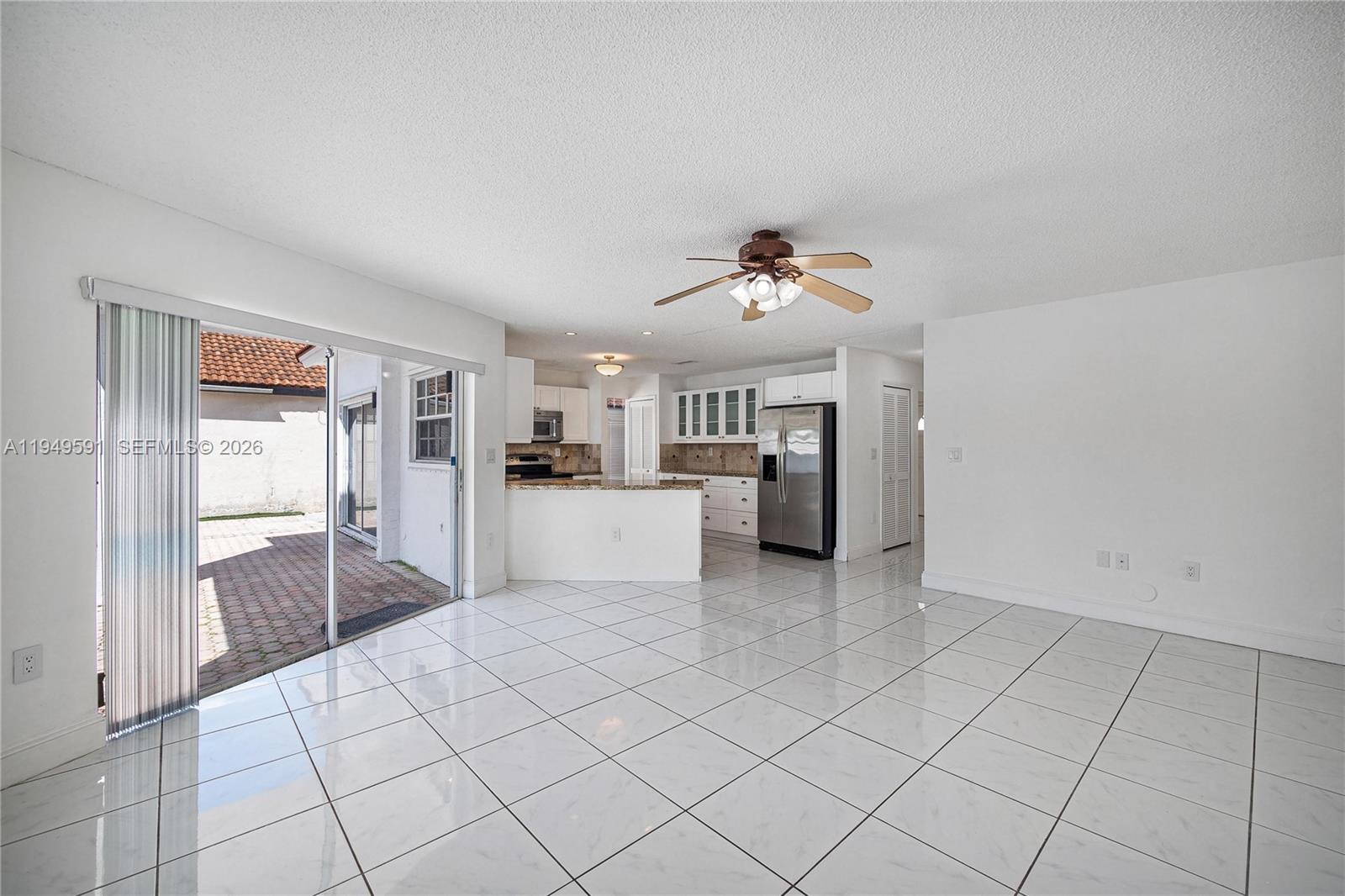 14340 Southwest 90th Street Miami, FL 33186 - Photo 16 of 34 a view of a kitchen with a sink and an empty room