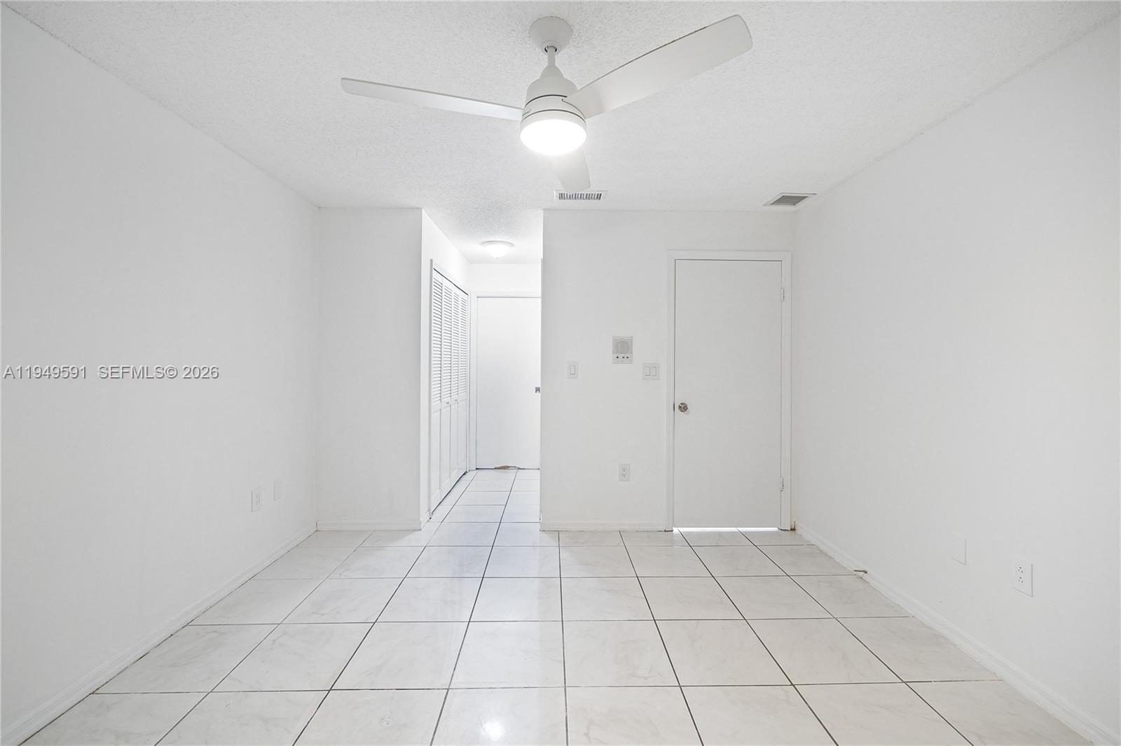 14340 Southwest 90th Street Miami, FL 33186 - Photo 21 of 34 an empty room with white walls and tiles