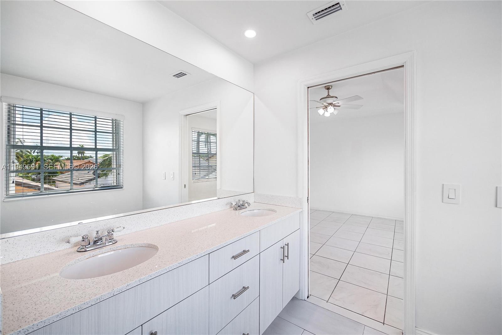 14340 Southwest 90th Street Miami, FL 33186 - Photo 27 of 34 a spacious bathroom with a shower sink and mirror