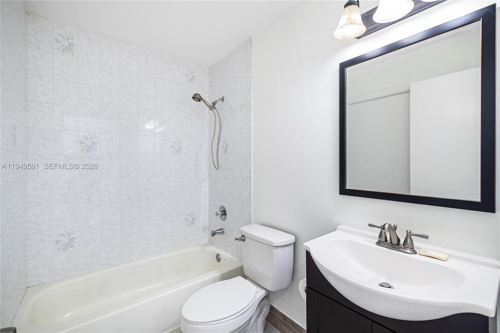 14340 Southwest 90th Street Miami, FL 33186 - Photo 29 of 34 a bathroom with a toilet a sink and a bathtub