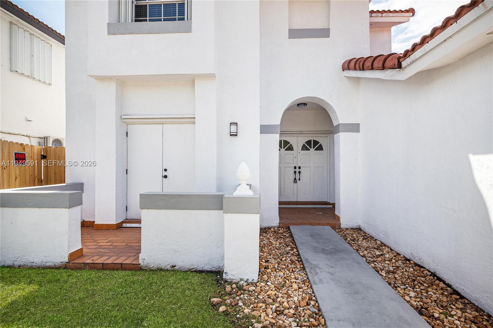14340 Southwest 90th Street Miami, FL 33186 - Photo 3 of 34 a front view of a house with garden