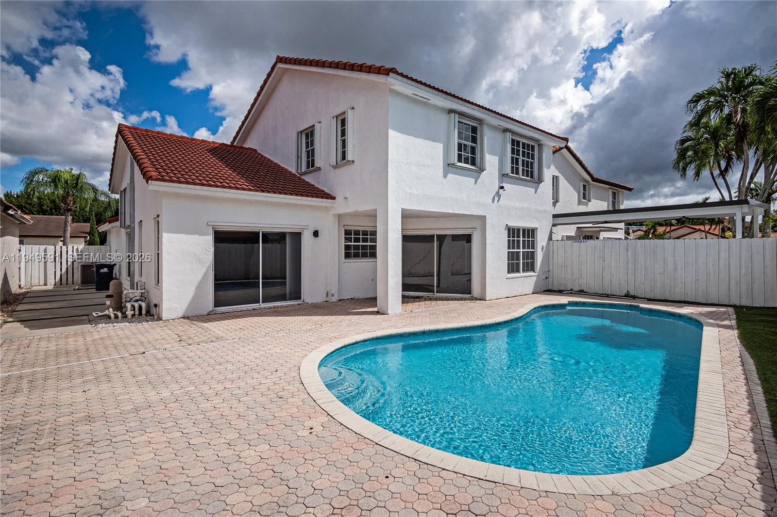 14340 Southwest 90th Street Miami, FL 33186 - Photo 32 of 34 a view of a house with swimming pool