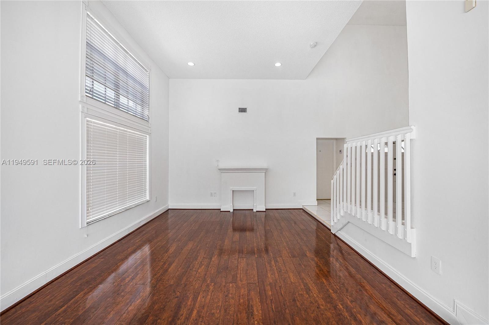 14340 Southwest 90th Street Miami, FL 33186 - Photo 6 of 34 an empty room with wooden floor and windows