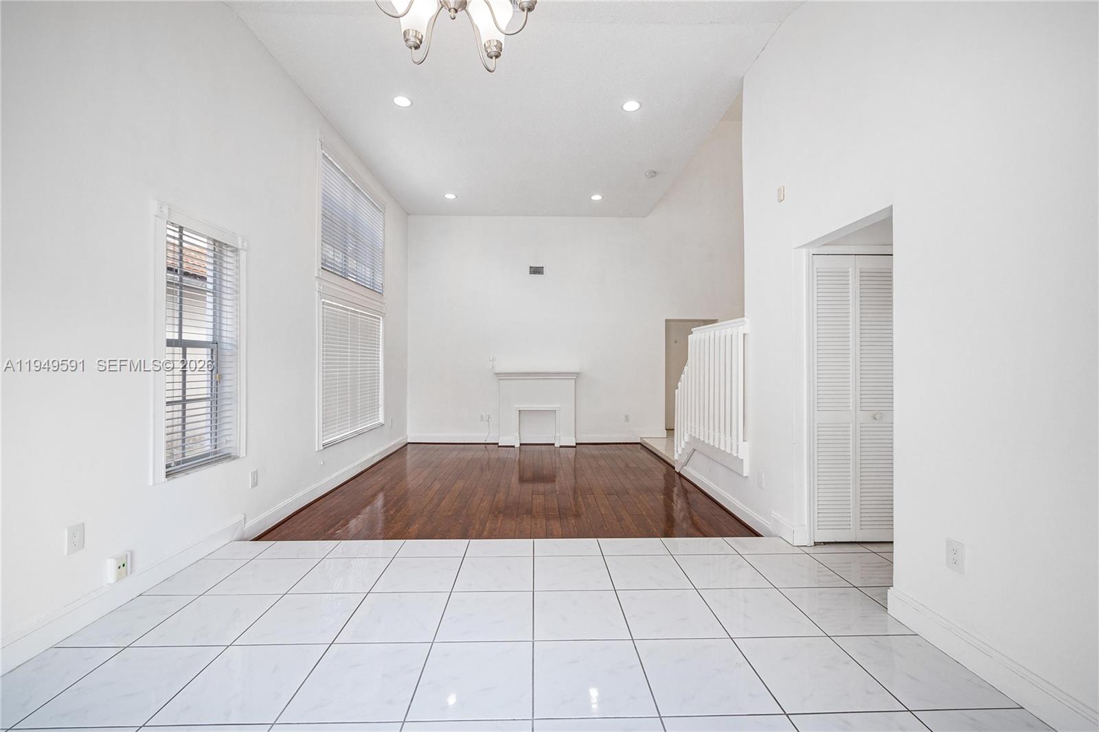 14340 Southwest 90th Street Miami, FL 33186 - Photo 10 of 34 a view of empty room with kitchen and window