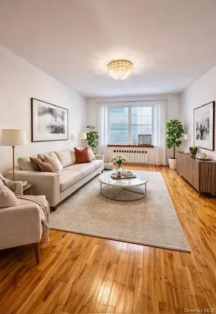 a living room with furniture and painting on the wall