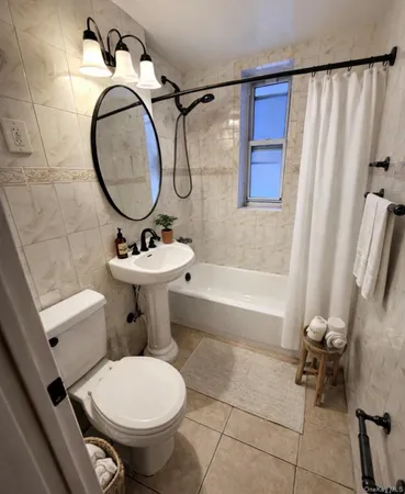 a bathroom with a sink toilet and a mirror