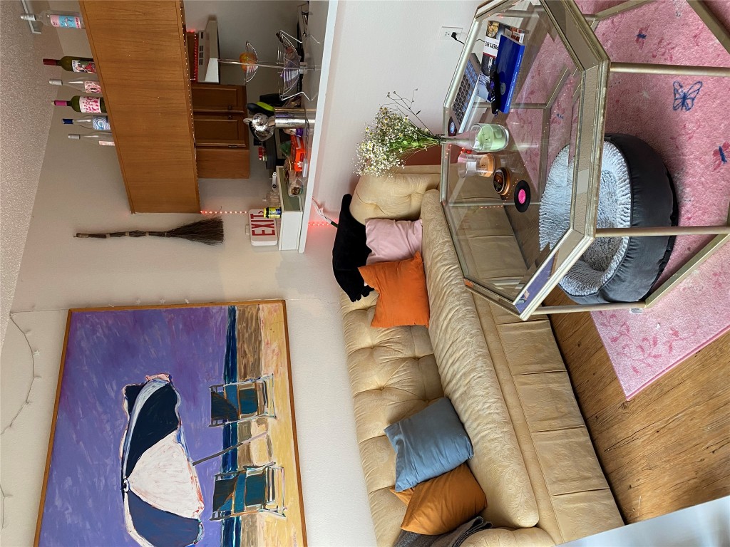 1905 San Gabriel Street, Unit 103 Austin, TX 78705 - Photo 12 of 21 a living room with furniture and a chair