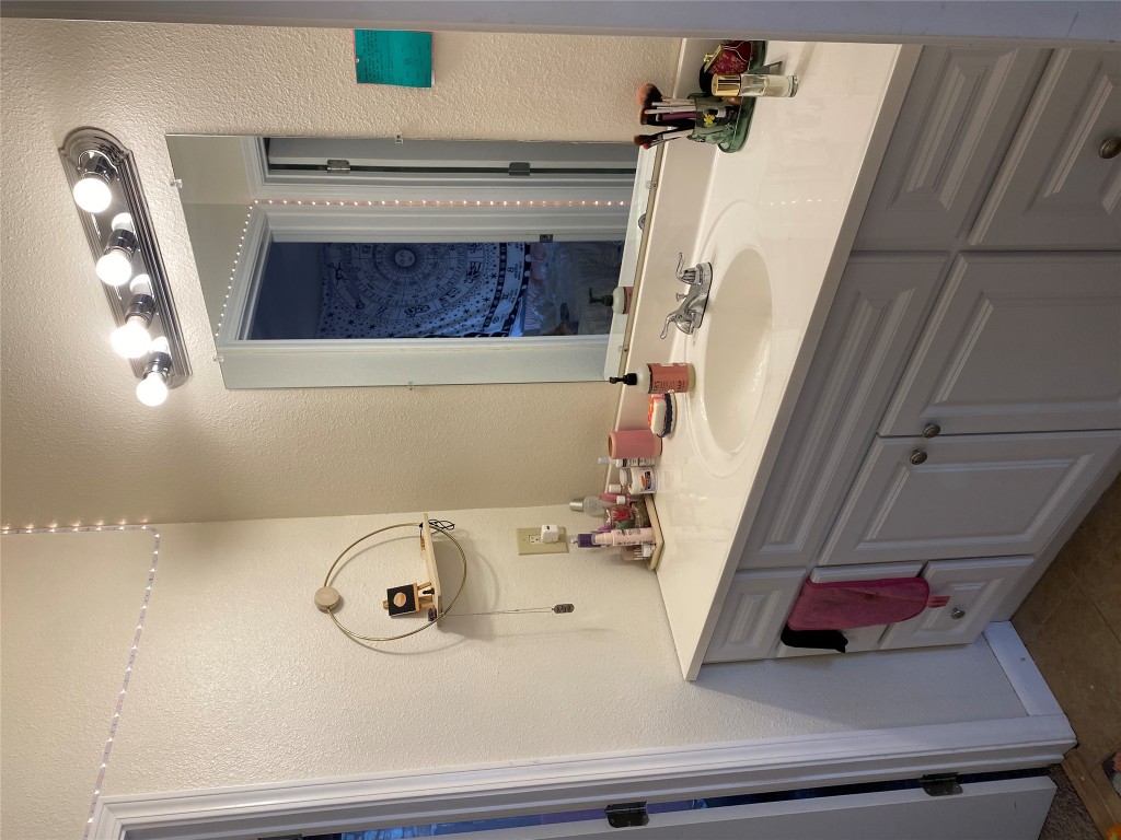 1905 San Gabriel Street, Unit 103 Austin, TX 78705 - Photo 17 of 21 a bathroom with a sink and a mirror