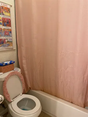 a bedroom with a bed and a large mirror on the dresser