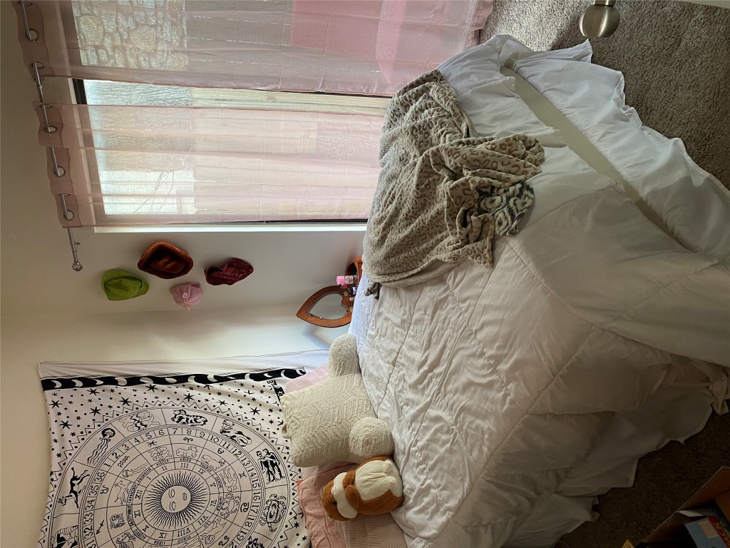 1905 San Gabriel Street, Unit 103 Austin, TX 78705 - Photo 19 of 21 a bedroom with a bed and a window