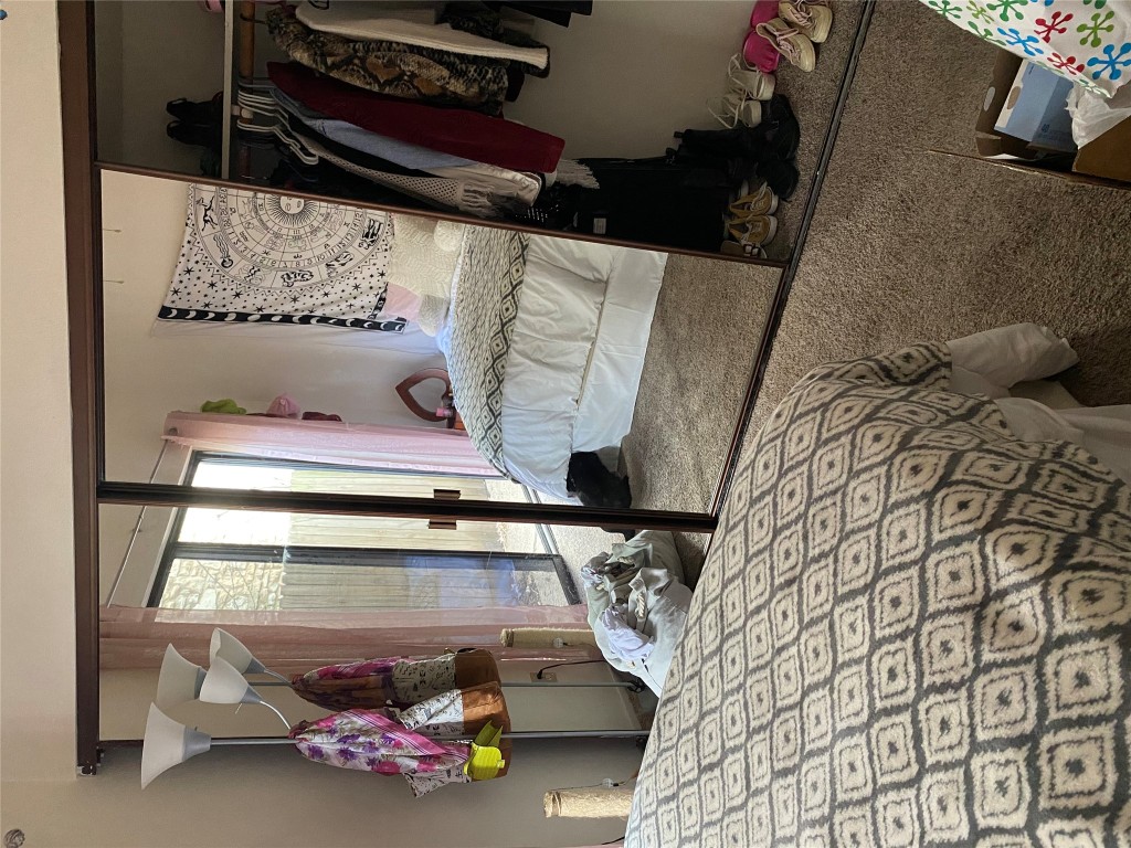 1905 San Gabriel Street, Unit 103 Austin, TX 78705 - Photo 21 of 21 a bedroom with a large bed and a chandelier