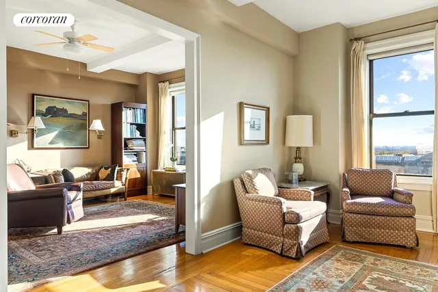 a living room with furniture wooden floor and a large window