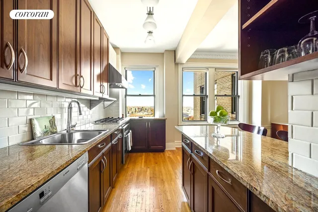 a kitchen with stainless steel appliances granite countertop a refrigerator and a sink