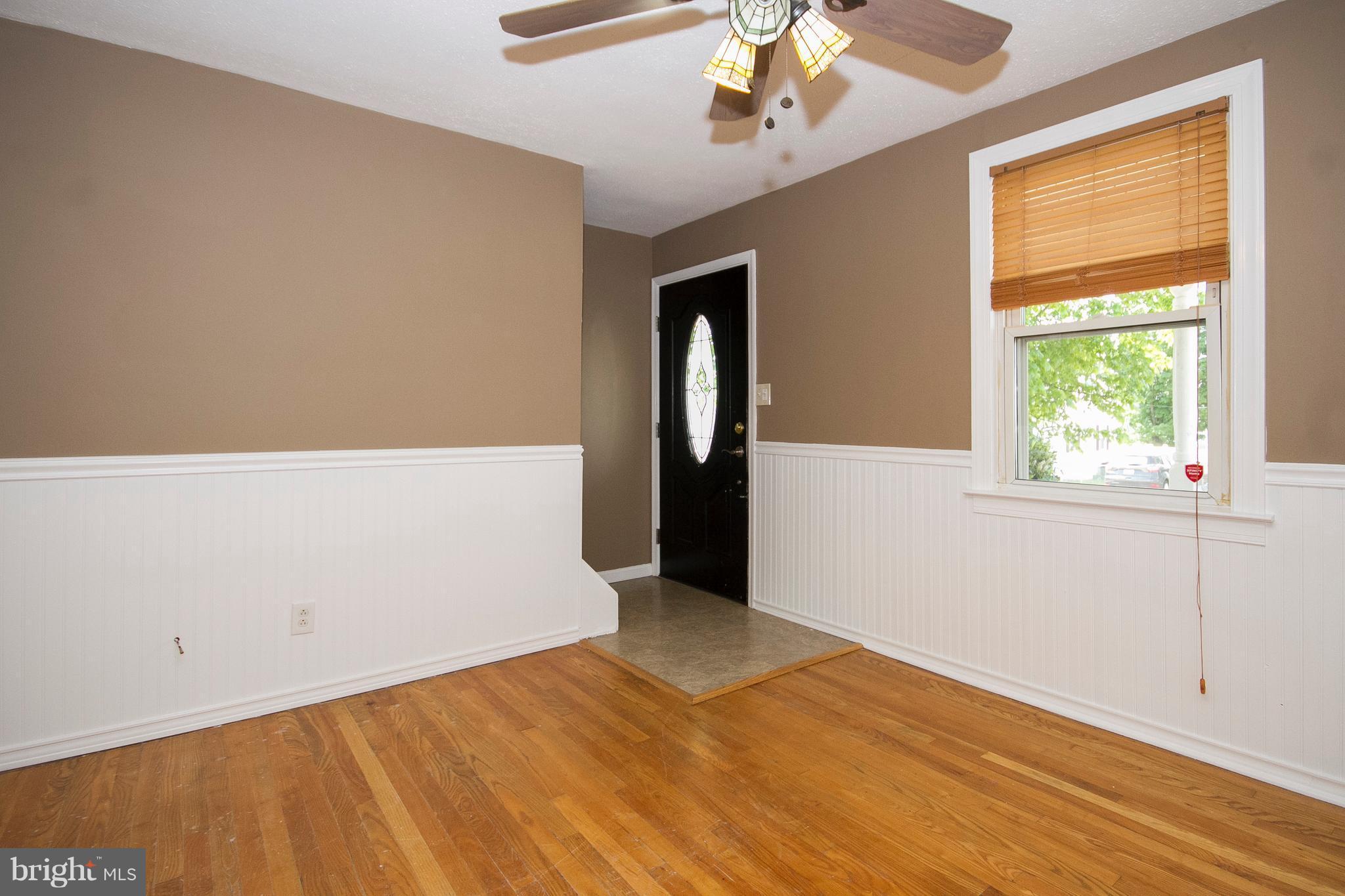 1713 Brookview Road Dundalk, MD 21222 - Photo 5 of 21 an empty room with a chandelier fan and windows