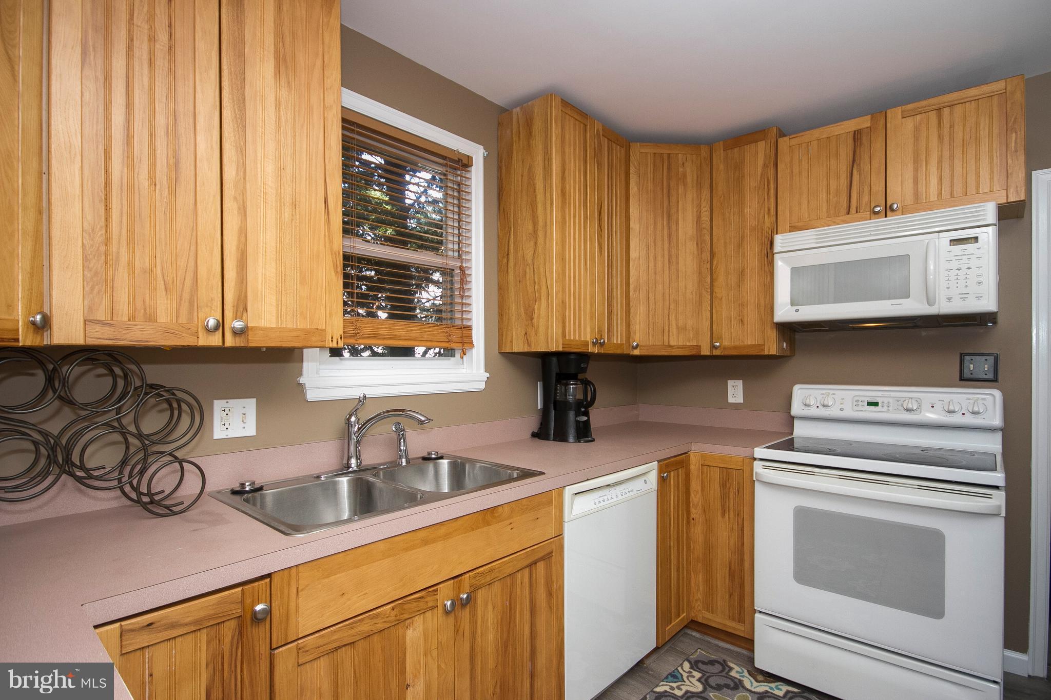 1713 Brookview Road Dundalk, MD 21222 - Photo 7 of 21 a kitchen with stainless steel appliances granite countertop a sink a stove and cabinets