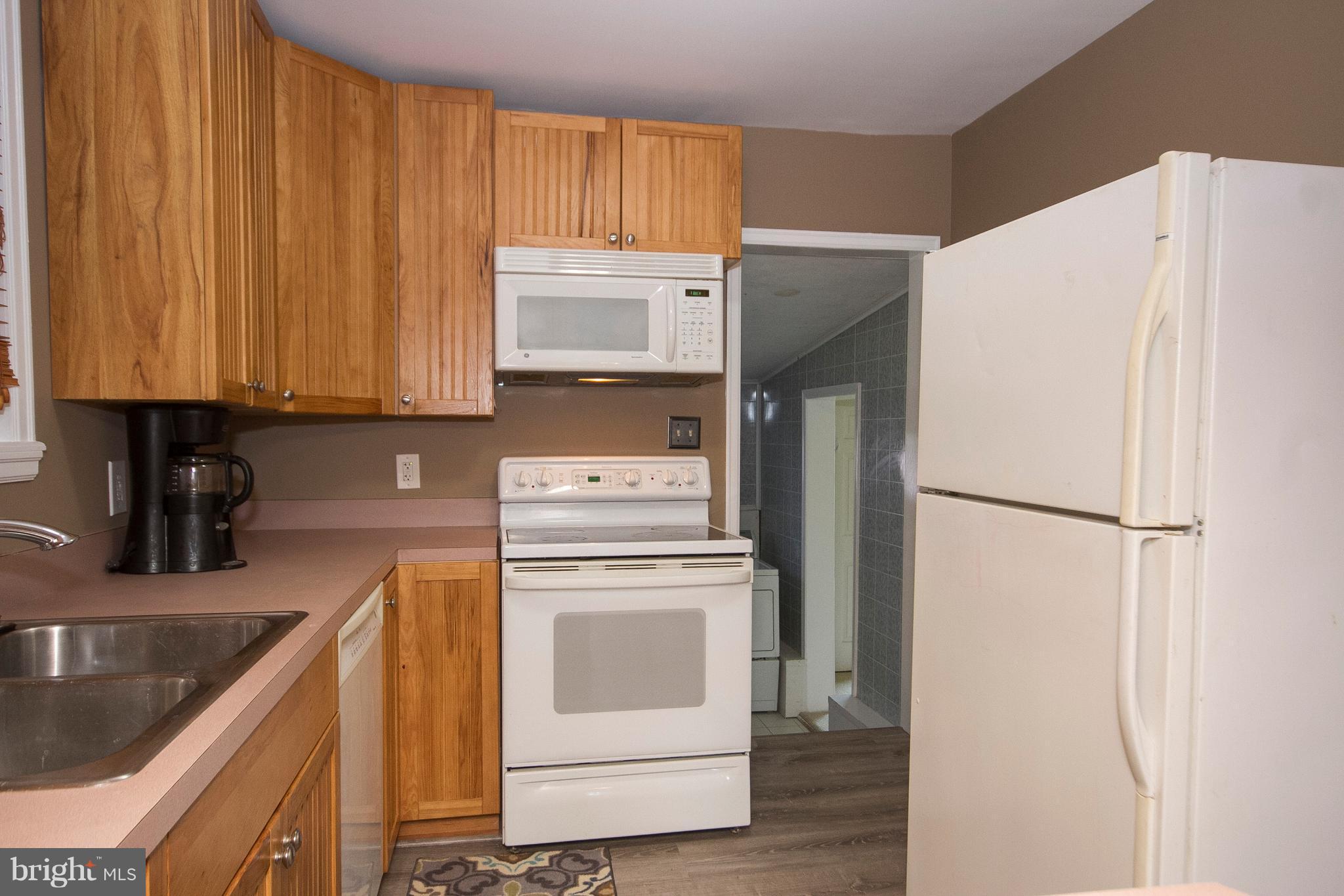1713 Brookview Road Dundalk, MD 21222 - Photo 9 of 21 a kitchen with a refrigerator sink and cabinets