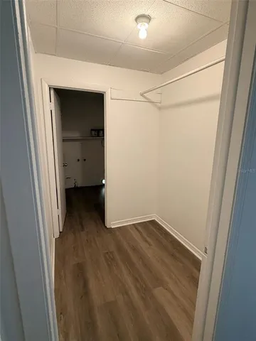 a room with wooden floor and mirror