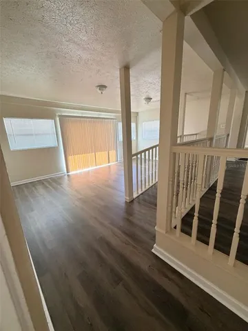 a view of a hallway view with wooden floor and staircase