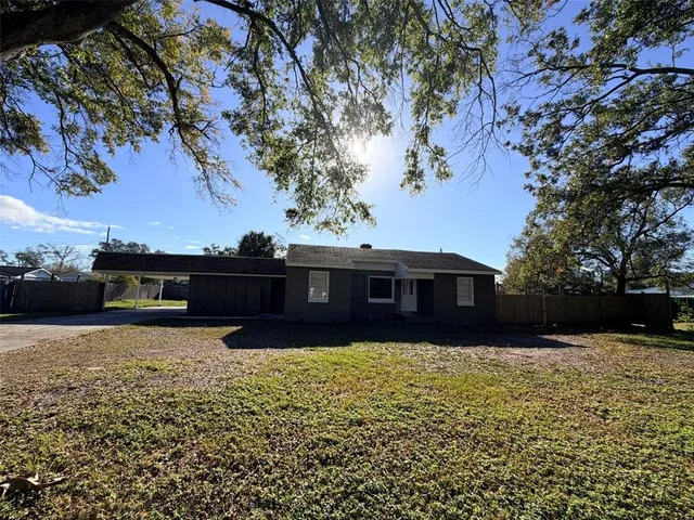 a view of house with a yard