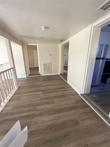 a view of a room with wooden floor