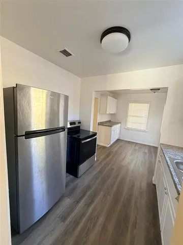a kitchen with a refrigerator and a sink