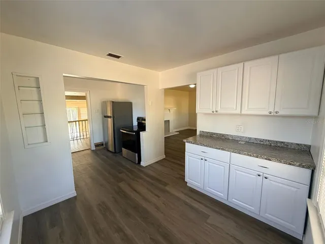 a kitchen with sink cabinets and wooden floor