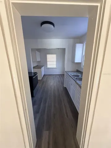 a kitchen with sink and cabinets