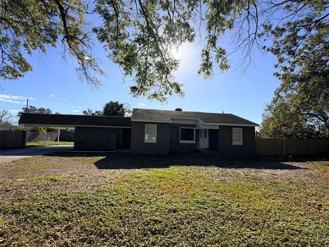 a front view of house with yard and trees
