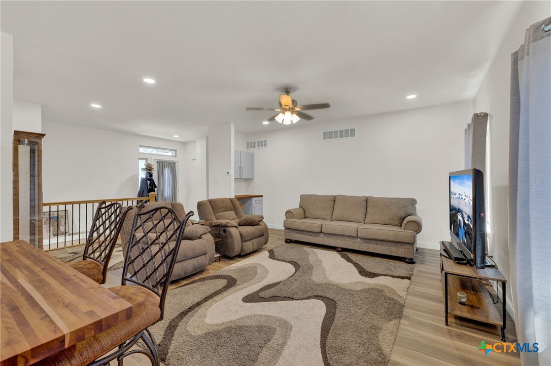 305 Lake Crest Spring Branch, TX 78070 - Photo 4 of 38 a living room with furniture and a chandelier