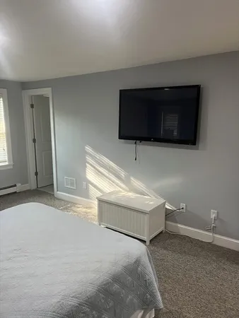 a bathroom with a sink a toilet a window and vanity