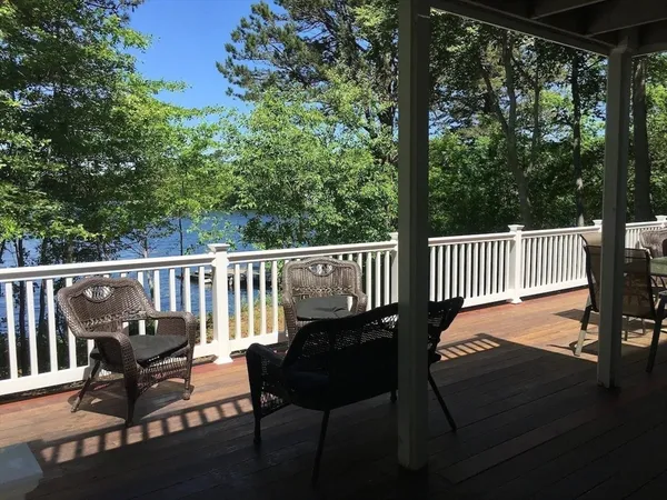 a view of a chairs and table on the wooden deck