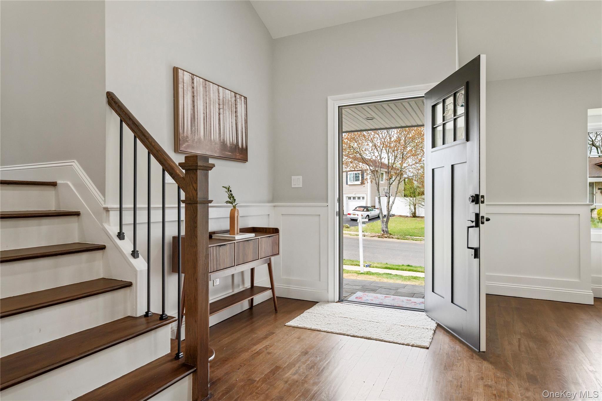 16 Eleanor Road Plainview, NY 11803 - Photo 2 of 28 Entryway featuring hard wood floors, white wainscoting