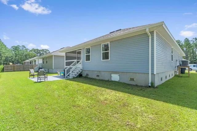 a view of a house with backyard porch and sitting area