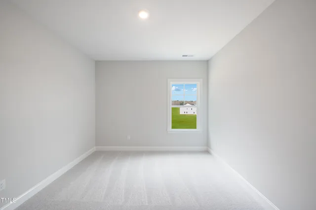 a view of an empty room and closet area