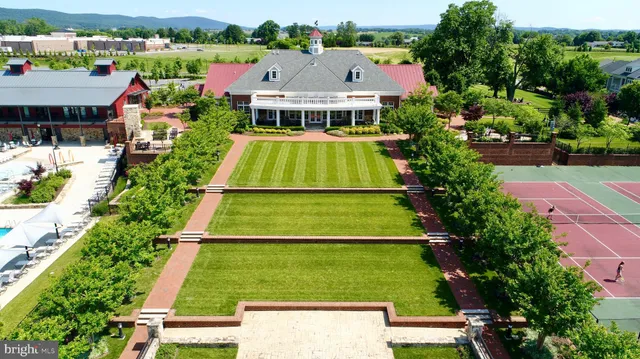 an aerial view of a residential houses with outdoor space and street view