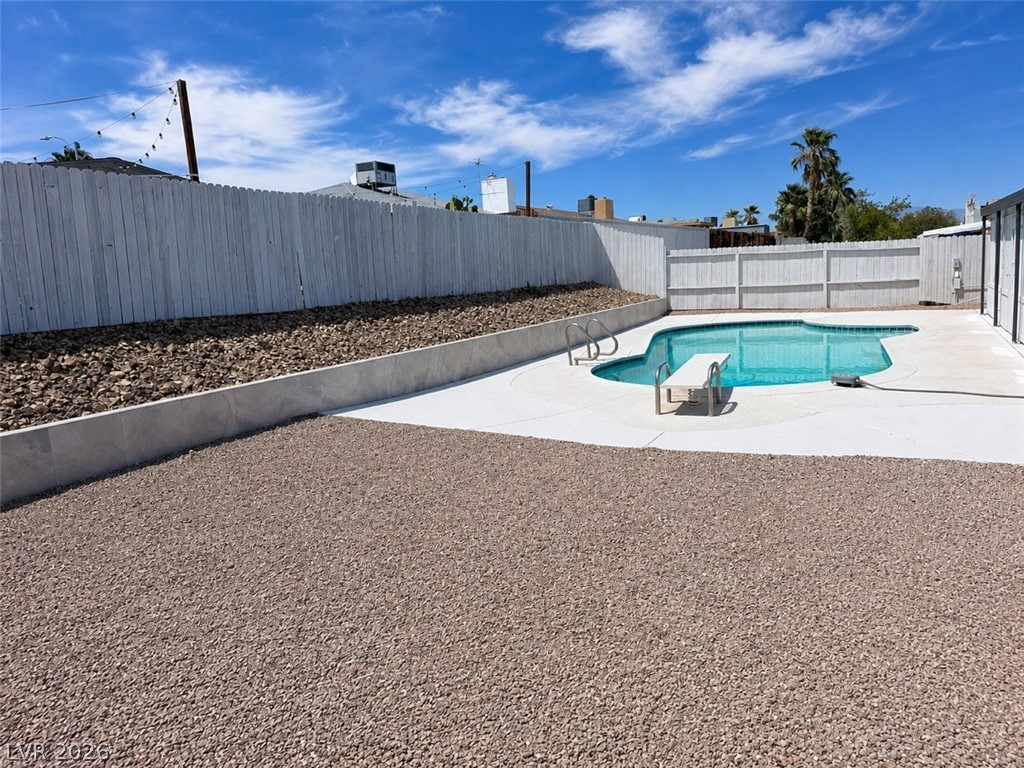 324 Lakehurst Road Las Vegas, NV 89145 - Photo 23 of 30 An inviting swimming pool anchors this private backyard enclosed by tall privacy fencing.