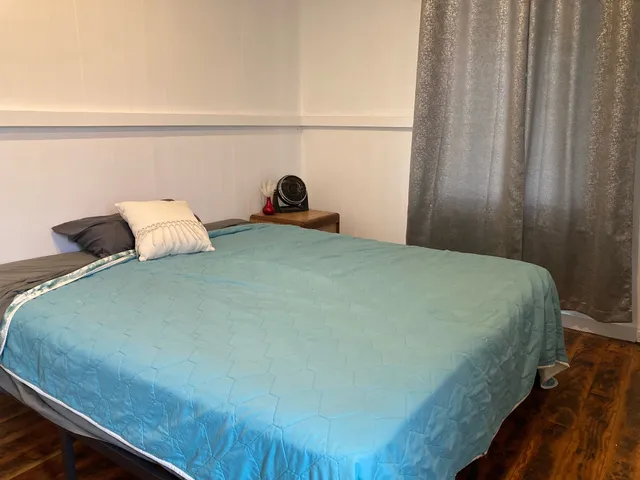 a bedroom with a bed and window