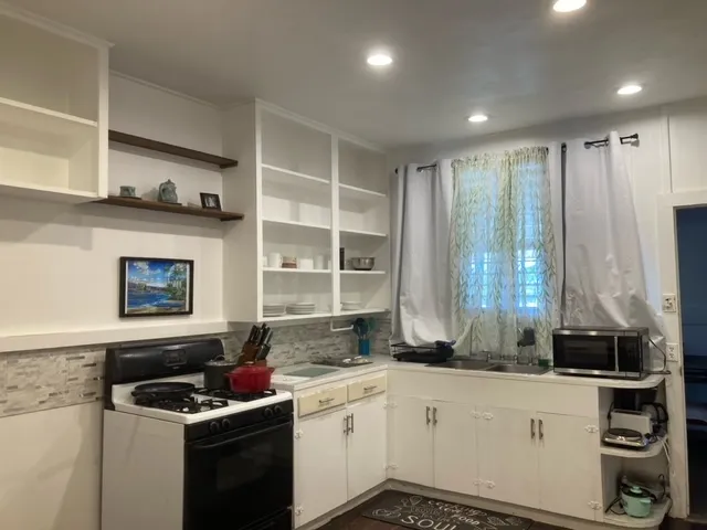 a kitchen with stainless steel appliances a stove and a sink
