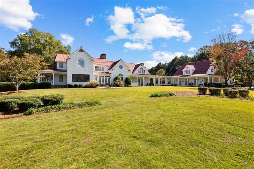 5225 Chalybeate Springs Road Woodland, GA 31836 - Photo 6 of 100 a view of a white house with a swimming pool and a yard