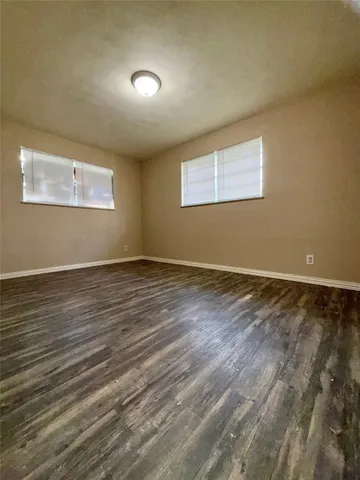 a view of room with wooden floor