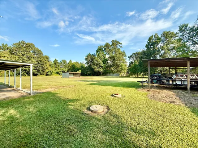 a view of a swimming pool and trees in the background