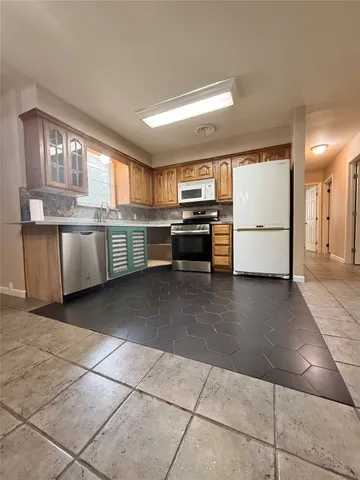 a kitchen with stainless steel appliances granite countertop a sink and cabinets
