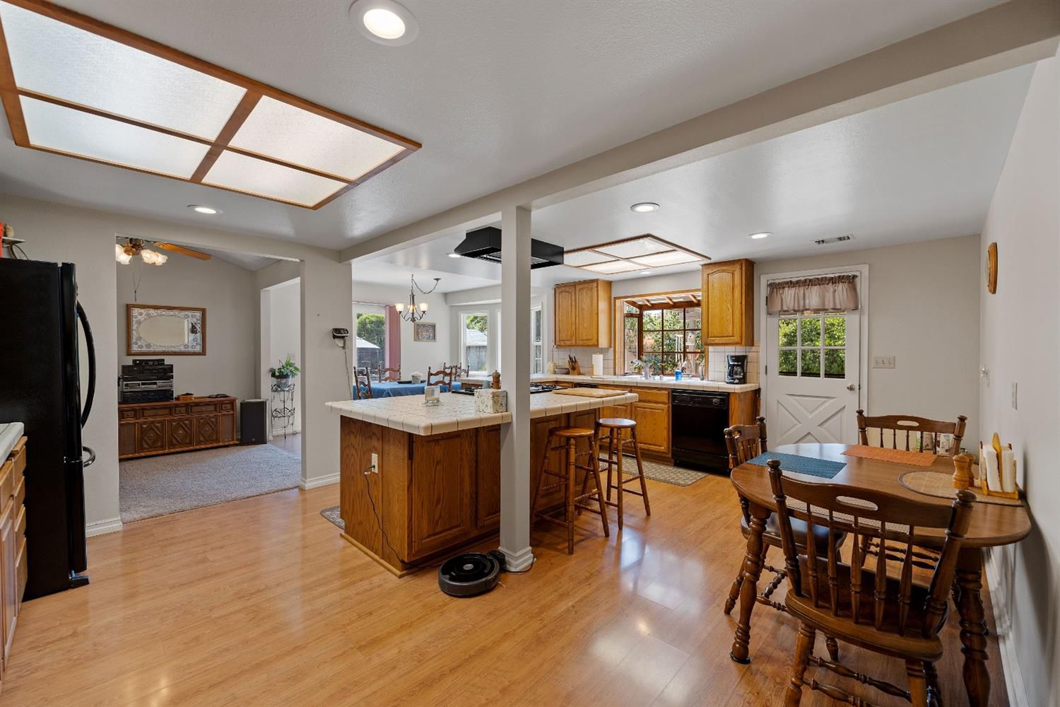 488 South Rice Road Ojai, CA 93023 - Photo 11 of 23 a dining hall with stainless steel appliances kitchen island granite countertop a table chairs and a living room view