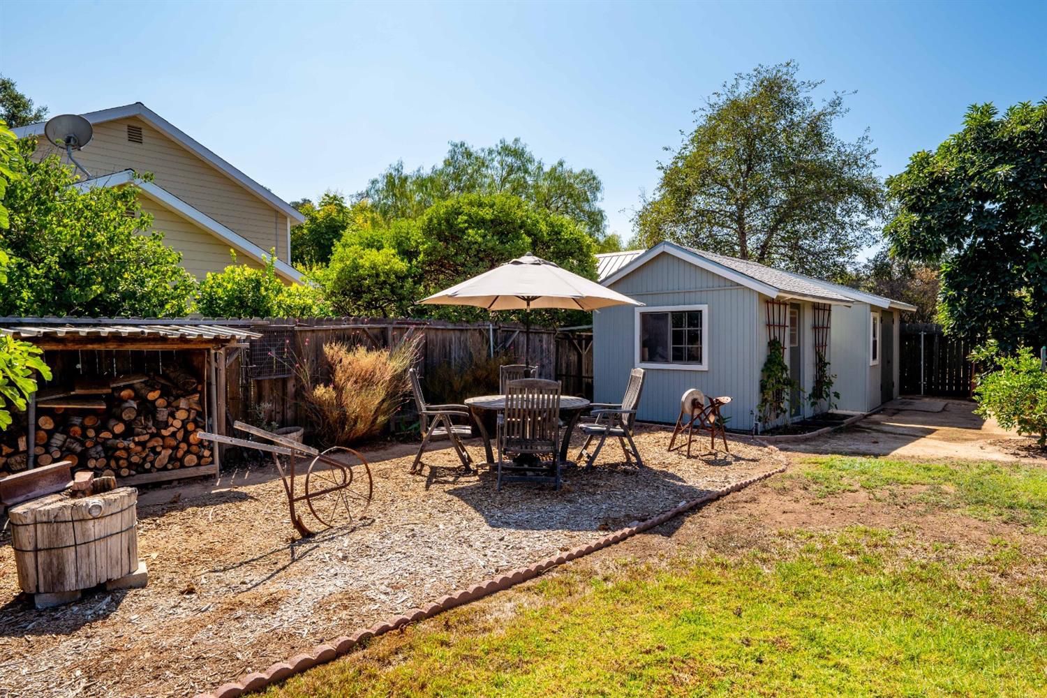 488 South Rice Road Ojai, CA 93023 - Photo 22 of 23 a patio table and chairs with potted plants and a barbeque