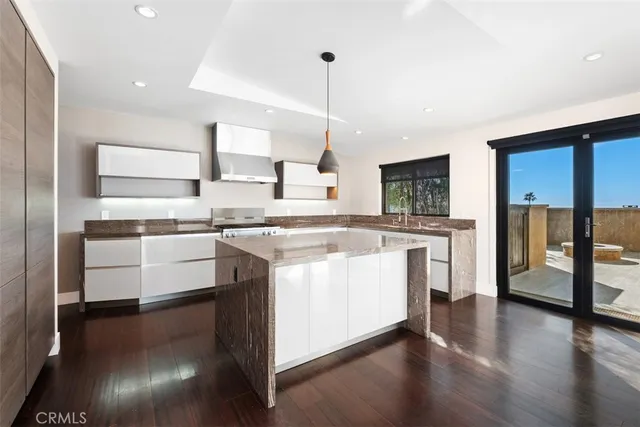 a kitchen with stainless steel appliances granite countertop a stove and a sink